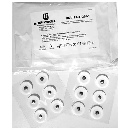 Ultratone pads ligger synlig i sin plastforpakning. Pads er runde, hvite og med sølvbit i midten.